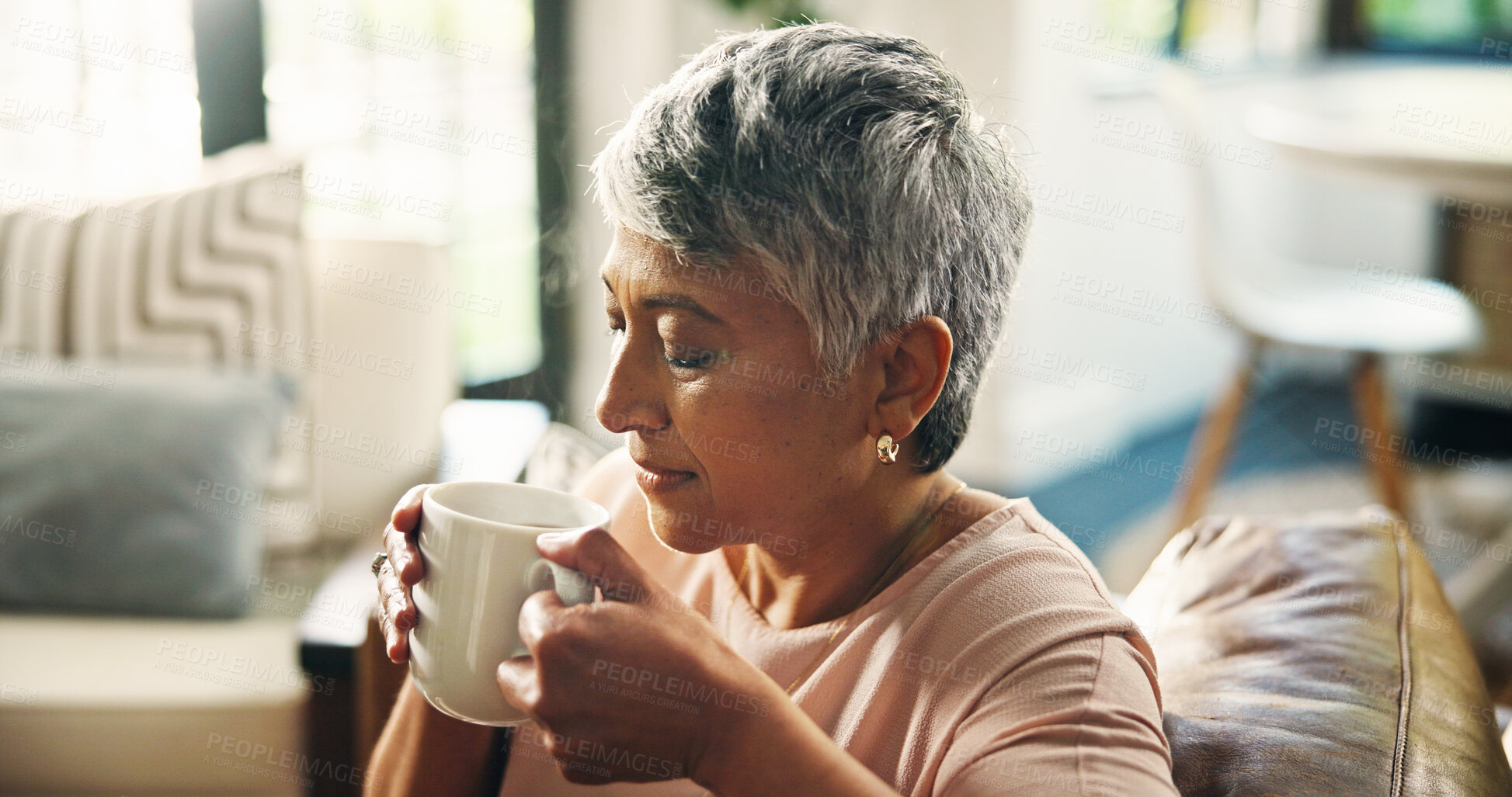 Buy stock photo Coffee, relax and senior woman on sofa in home with calm and peace in living room in morning. Happy, memory and elderly female person in retirement drinking cappuccino on couch in house on break.