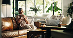 Old woman, tea cup and thinking with smile on sofa in home, memory or reflection for nostalgia in living room. Person, coffee and happy with drink, relax and remember on couch in retirement at house