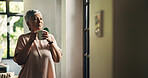 Senior woman, coffee and thinking by window in home, memory or reflection for nostalgia in morning. Person, tea cup and perspective with beverage, drink and remember with inspiration in retirement