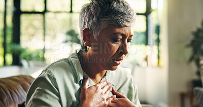 Buy stock photo Living room, chest pain and senior woman with heartburn, health risk or angina with medical emergency. Retirement, heart attack and person with cardiovascular disease, cardiac arrest and hypertension