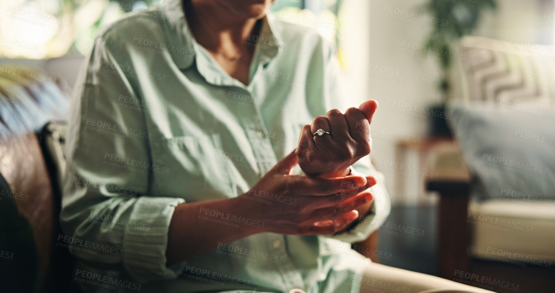 Buy stock photo Wrist pain, hands and injury with old woman on sofa for osteoporosis, arthritis and emergency. Parkinson cramp, mobility risk and anatomy with senior person in living room of home for fibromyalgia