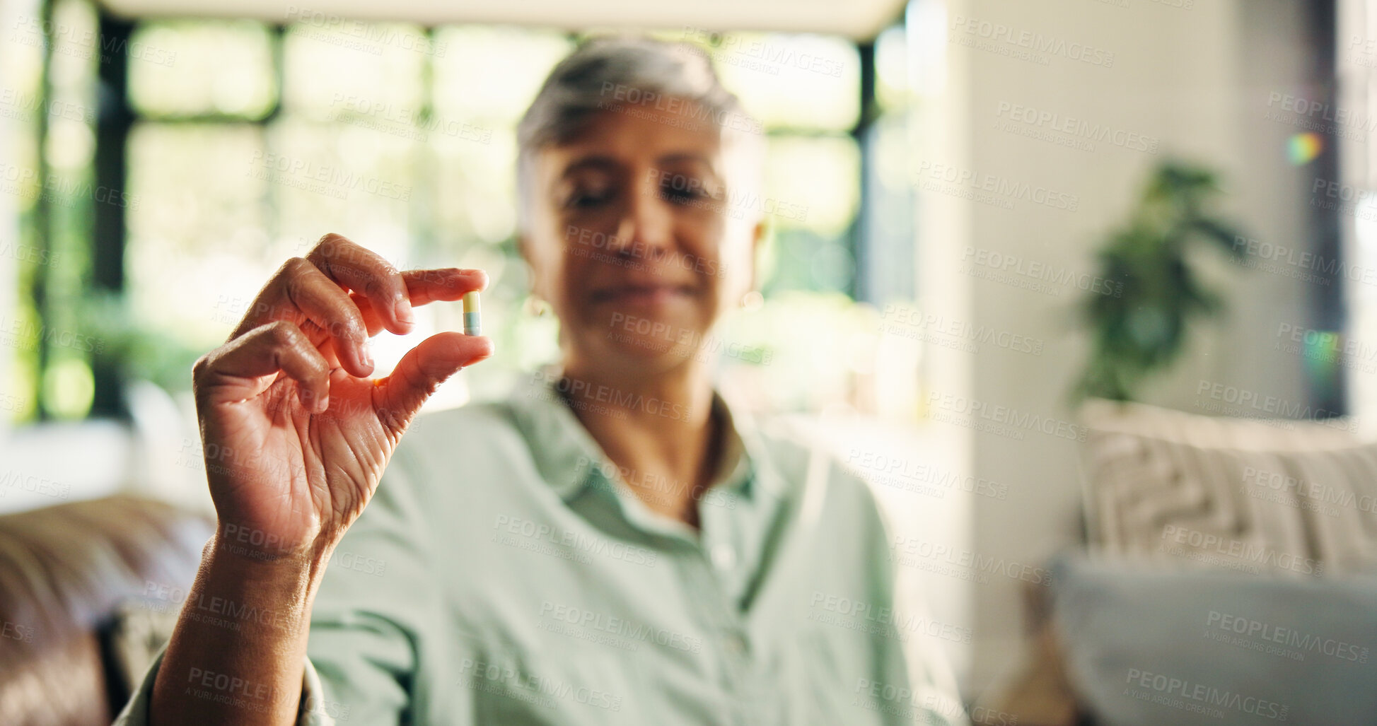 Buy stock photo PIll, hand and senior woman at house for daily dose, healthcare and medicine for healing. Health, wellness and female person with tablet for vitamins, drugs or pharmaceutical help in living room