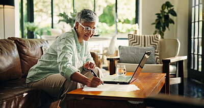Buy stock photo Mature woman, remote work and writing on document for finance, budget review and asset management. Laptop, freelancer and happy person with paper in living room for accounting or tax return in home