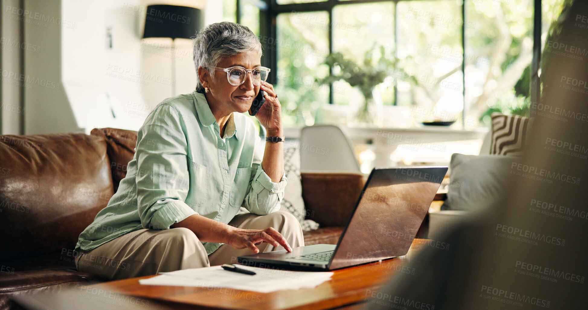 Buy stock photo Budget, finance or senior woman with phone call by laptop for annuity fund, tax planning or banking. Wealth, old person and talking to consultant in home for retirement savings account or bills query