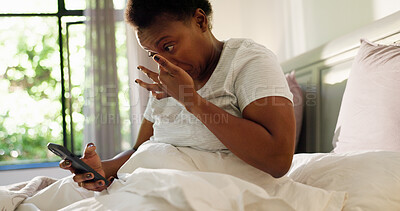 Buy stock photo Black woman, phone and wake up with texting in bed, tired and snooze alarm in morning at home. African person, exhausted and check notification with smartphone, click and mobile app in bedroom