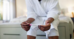 Read, results and hands with pregnancy test, waiting and woman with pee stick to confirm in bedroom. Review, info and black person with home exam kit, check and tool for outcome on bed and apartment