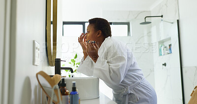 Buy stock photo African woman, makeup brush and foundation in bathroom, home and mirror for application with morning routine. Person, tools and cosmetics in profile with skin for transformation, powder and beauty