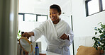 Happy, home and black woman in morning in bathroom for cleaning, washing face and grooming. Daily routine, beauty and person with products for skincare, hygiene and wellness for health in house