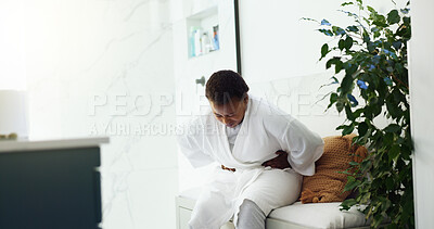Buy stock photo Pain, black woman and stomach cramps in bathroom for IBS disease, gastritis and uncomfortable ache. Morning, person and tummy discomfort in home for belly indigestion, constipation or endometriosis