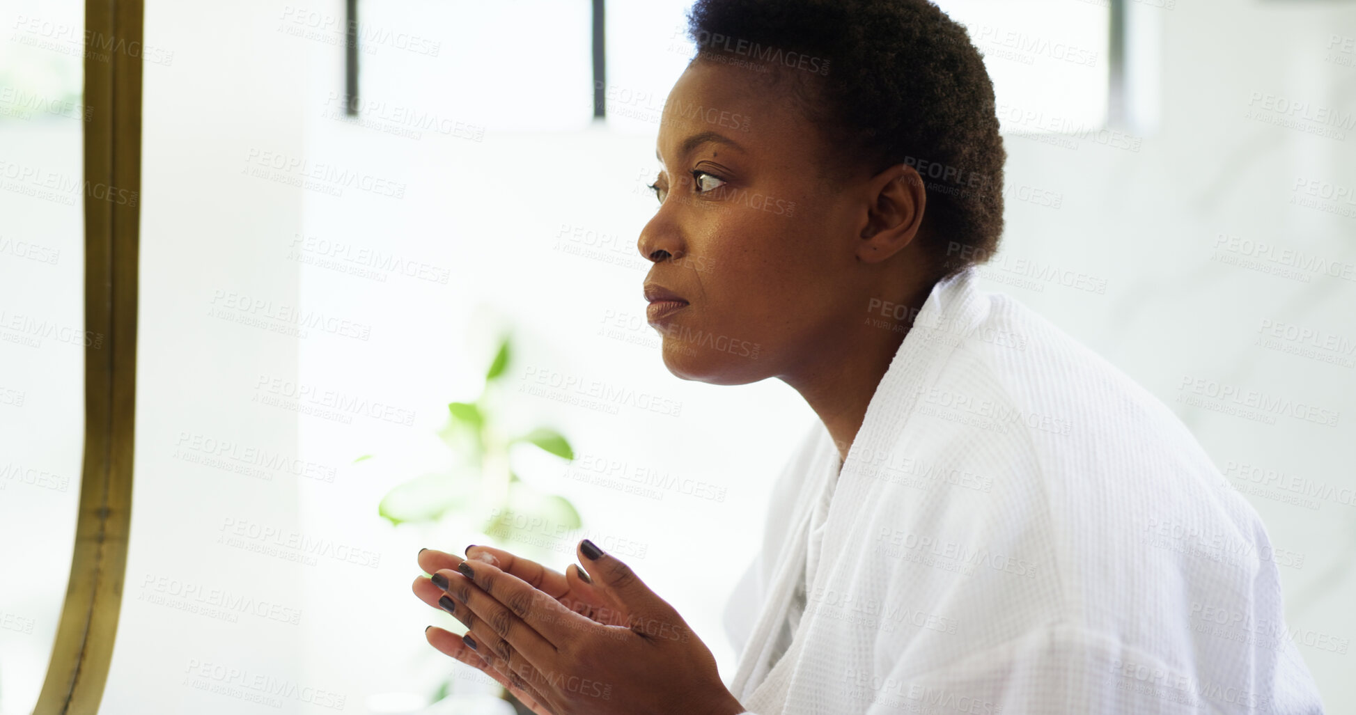 Buy stock photo Grooming, routine and woman with mirror, bathroom and cosmetics for smooth skin, think and skincare. Home, serious and black person with moisturizer for facial treatment, dermatology and self care