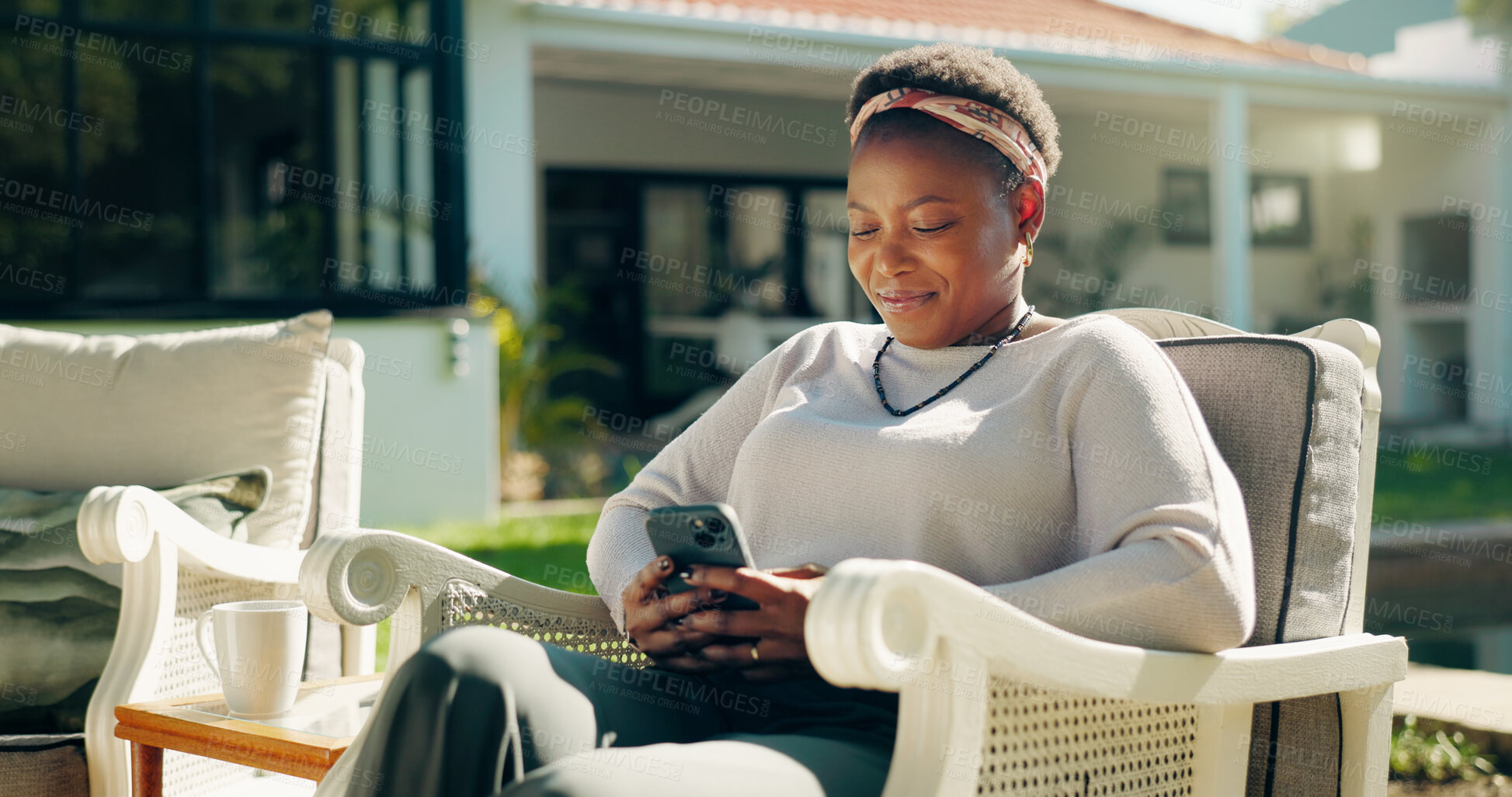 Buy stock photo Relax, holiday and black woman with phone in backyard on social media, blog or online review. Guest house, outdoor and female person with mobile for text, feedback or reading accommodation website
