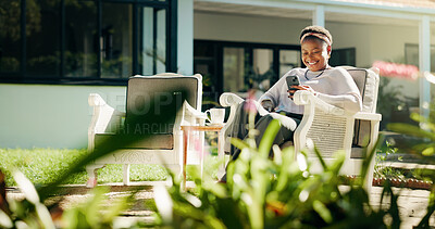 Buy stock photo Chair, garden or black woman in backyard with phone, social media joke or online review. Guest house, outdoor or happy female person with mobile for text, funny meme or reading accommodation website