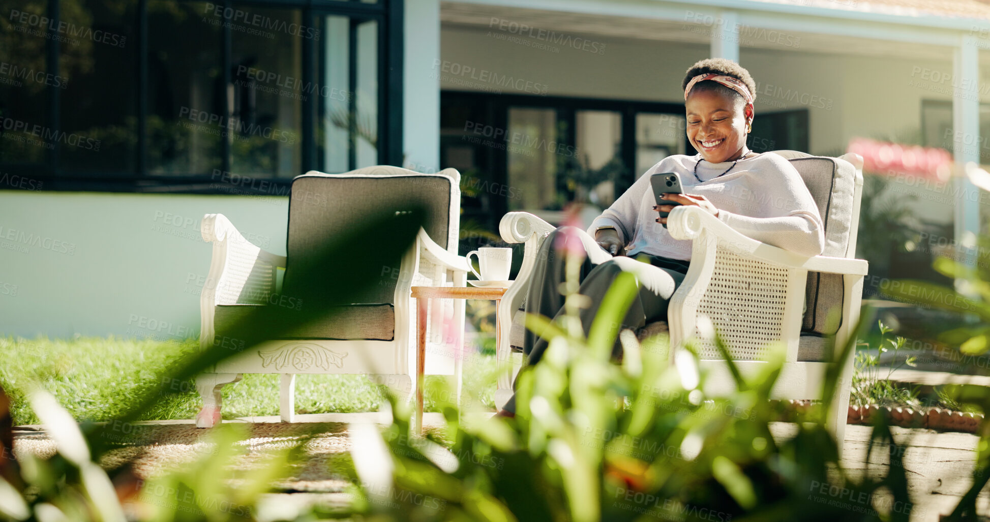 Buy stock photo Chair, garden or black woman in backyard with phone, social media joke or online review. Guest house, outdoor or happy female person with mobile for text, funny meme or reading accommodation website