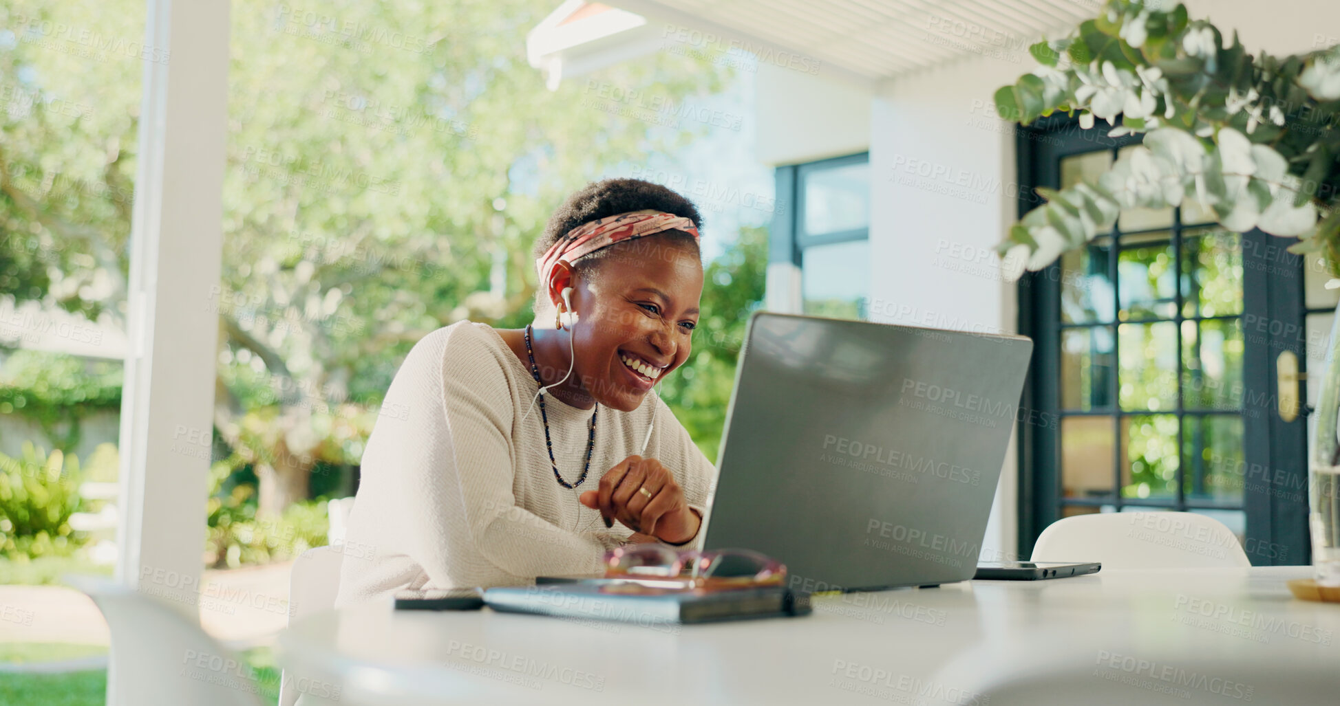 Buy stock photo Video call, remote work and black woman on laptop in home for contact, online chat and virtual meeting. Communication, creative freelancer and earphones for discussion, talking and webinar on patio