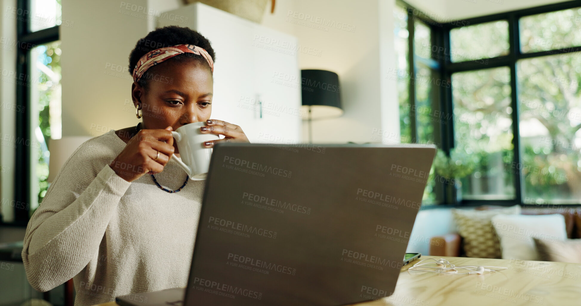 Buy stock photo Black woman, drink and coffee with laptop at house for remote work, review article and proofreading. Female freelancer, beverage and online for research, story feedback and news update of publication