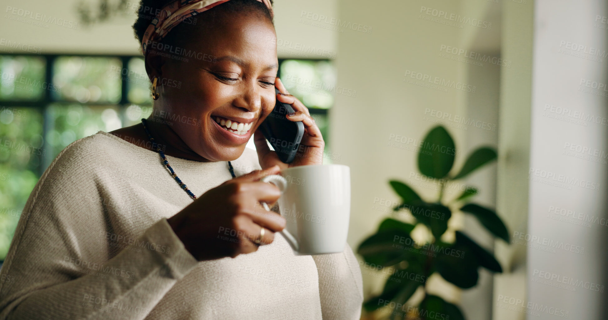 Buy stock photo African woman, phone call and laugh in home with coffee, conversation and listen in living room. Person, happy and smartphone with drink for chat, joke and tea cup with funny discussion at apartment