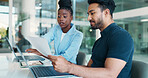 Office, colleagues and people with document, pointing and review of financial performance or online. Collaboration, man and woman with paperwork for sales, discussion and reading of report or laptop