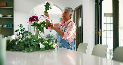 Buy stock photo Senior woman, arrangement and flowers at house for special occasion, aesthetic and natural bloom. Elderly person, bouquet and plant care with floral beauty, hospitality decoration and setup of resort