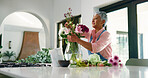 Vase, flowers and senior woman with bouquet, retirement and natural with decorations. Pensioner, apartment and elderly person with gift, plants and hobby with happiness, blooming and house with break