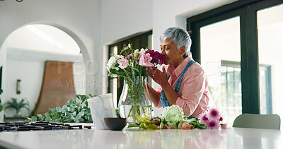 Buy stock photo Old woman, smell and flowers in vase at house of special occasion, aesthetic and bloom scent. Senior person, arrangement and plant fragrance of floral bouquet, hospitality decoration and resort setup