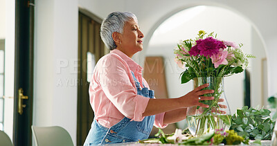 Buy stock photo Elderly woman, flowers and vase at house for special occasion, aesthetic and natural bloom. Senior person, arrangement and plant care with floral bouquet, hospitality decoration and beauty in lounge