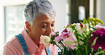 Smile, house and senior woman with flowers, bouquet present and happiness. Pensioner, apartment and elderly person with gift, natural and relax with plants, retirement and hobby with floral aroma
