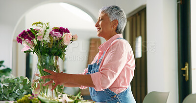 Buy stock photo Senior woman, flowers and vase at house for special occasion, aesthetic and natural bloom. Elderly person, arrangement and plant care with floral bouquet, hospitality decoration and beauty in lounge