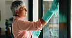 Cleaning, window and senior woman with cloth for hygiene, housekeeping and maid service. Washing, glass and mature person with shine, detergents and liquid for bacteria, disinfection and dust in home