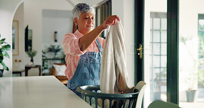 Buy stock photo Senior woman, cleaning and folding laundry in home for housekeeping or hygiene maintenance. Daily housework, person and fabric in basket for chores, morning routine or organizing cotton in retirement
