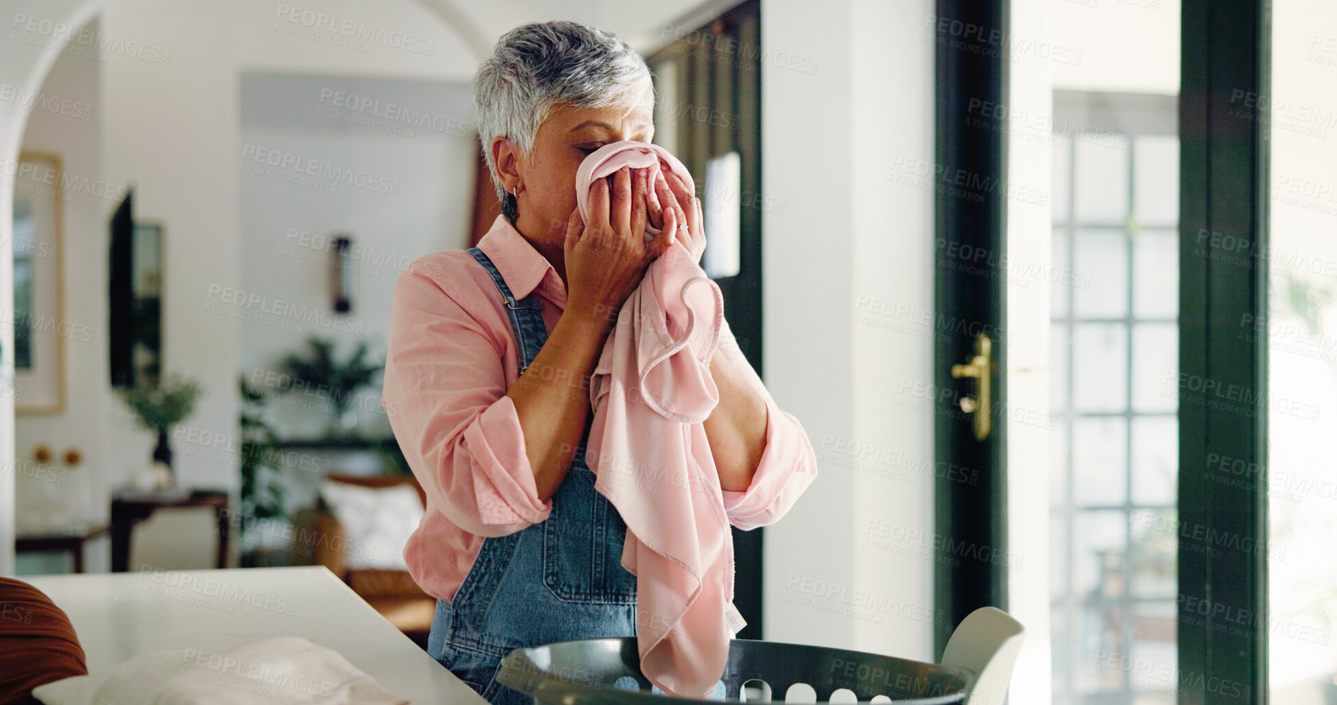 Buy stock photo Sniffing, cloth and woman with laundry, home and smell of clean washing, fragrance and housekeeping. Fabric, scent and mature person with chores in house, cleaner and odor of material or hygiene