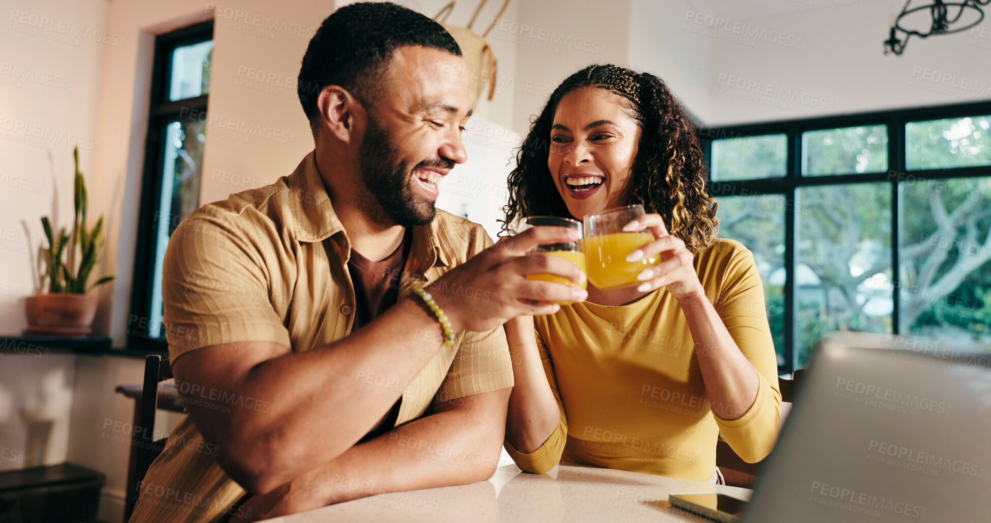 Buy stock photo Home, toast and couple with juice, smile and bonding together with love, celebration and marriage. Apartment, healthy man or woman with laptop, nutrition and natural drink with cheers or relationship