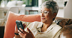 Mature woman, smartphone and smile on couch with contact, relax and notification on web in home. Person, hone and happy with mobile app, post and texting on social network in lounge at apartment