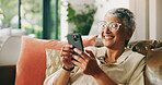 Smile, reading and phone with old woman on sofa for social media news, update and text message. Laugh, happiness and online chat with senior person in living room of home for communication app