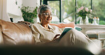 Senior, woman and reading a book on sofa for cognition, literature story or retirement hobby. Happy, old person or relax with best seller novel in home for fantasy fiction, knowledge or weekend break