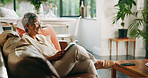 Old woman, happy and reading a book on sofa for cognition, literature story and retirement hobby. Senior, reader and best seller novel in home for fantasy fiction, leisure activity and weekend break