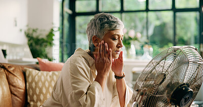 Buy stock photo Senior woman, hot and fan at house for heatwave, air conditioning and menopause symptoms. Elderly person, sweat and electric appliance for cool breeze, warm weather and relief from hormonal condition