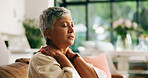 Neck pain, tension and senior woman on sofa in home with discomfort, tired and stiff muscle. Elderly, stress and massaging sore shoulder for fibromyalgia, ache or pinched nerve problem in retirement