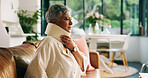Home, injury and woman with neck brace, thinking and discomfort of fracture, pain or hurt in lounge. Accident, recovery and C collar to support spinal cord, house and healthcare for elderly person