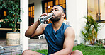 Drinking water, fitness and man on break, home or athlete with liquid for hydration, health or rest. Thirsty, person and wellness with drink to prevent dehydration, house and relax with beverage