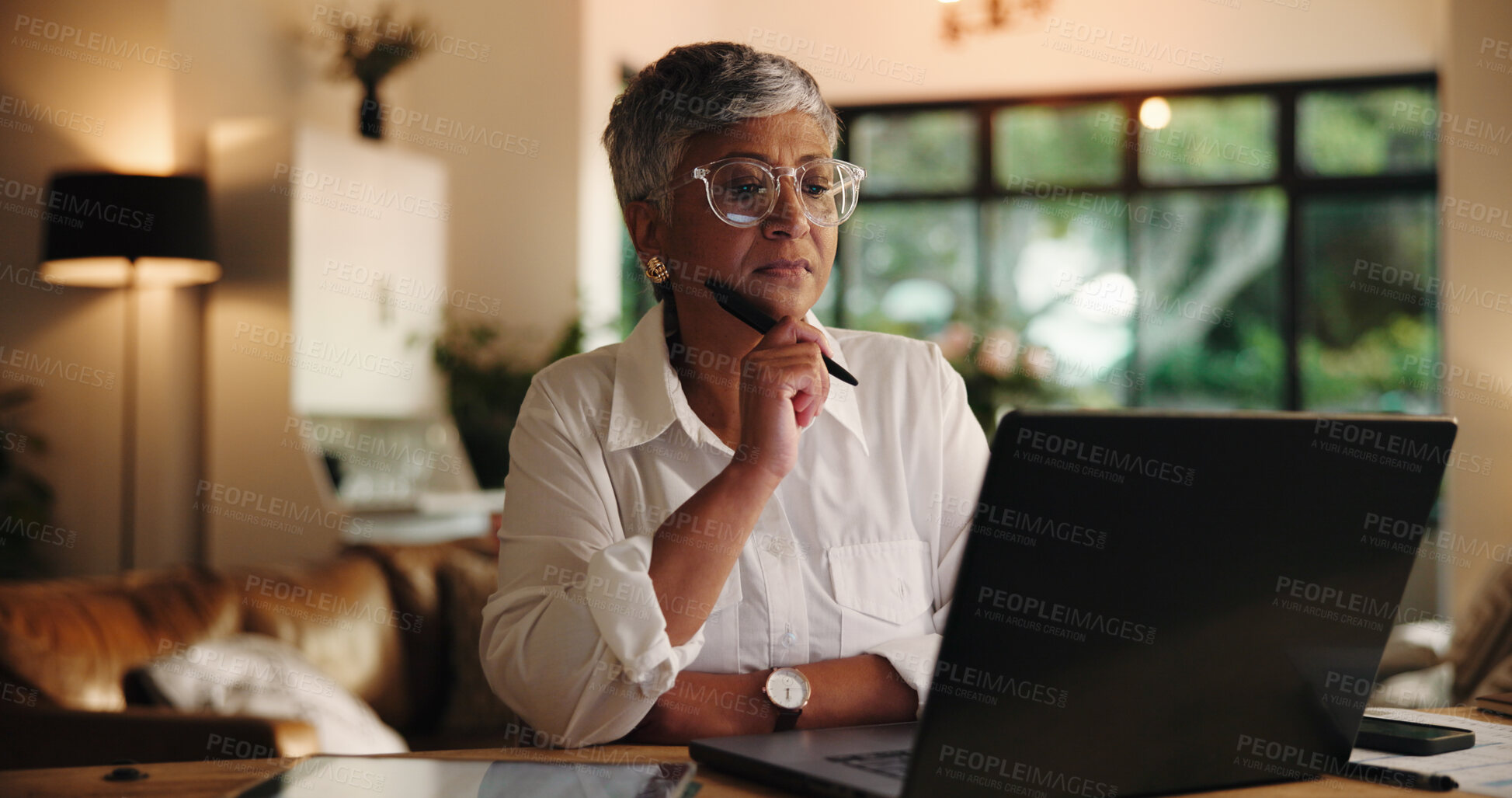 Buy stock photo Mature woman, laptop and remote work from home with decision, review or notes for project management. Person, virtual assistant and computer with insight, feedback and freelance career at apartment