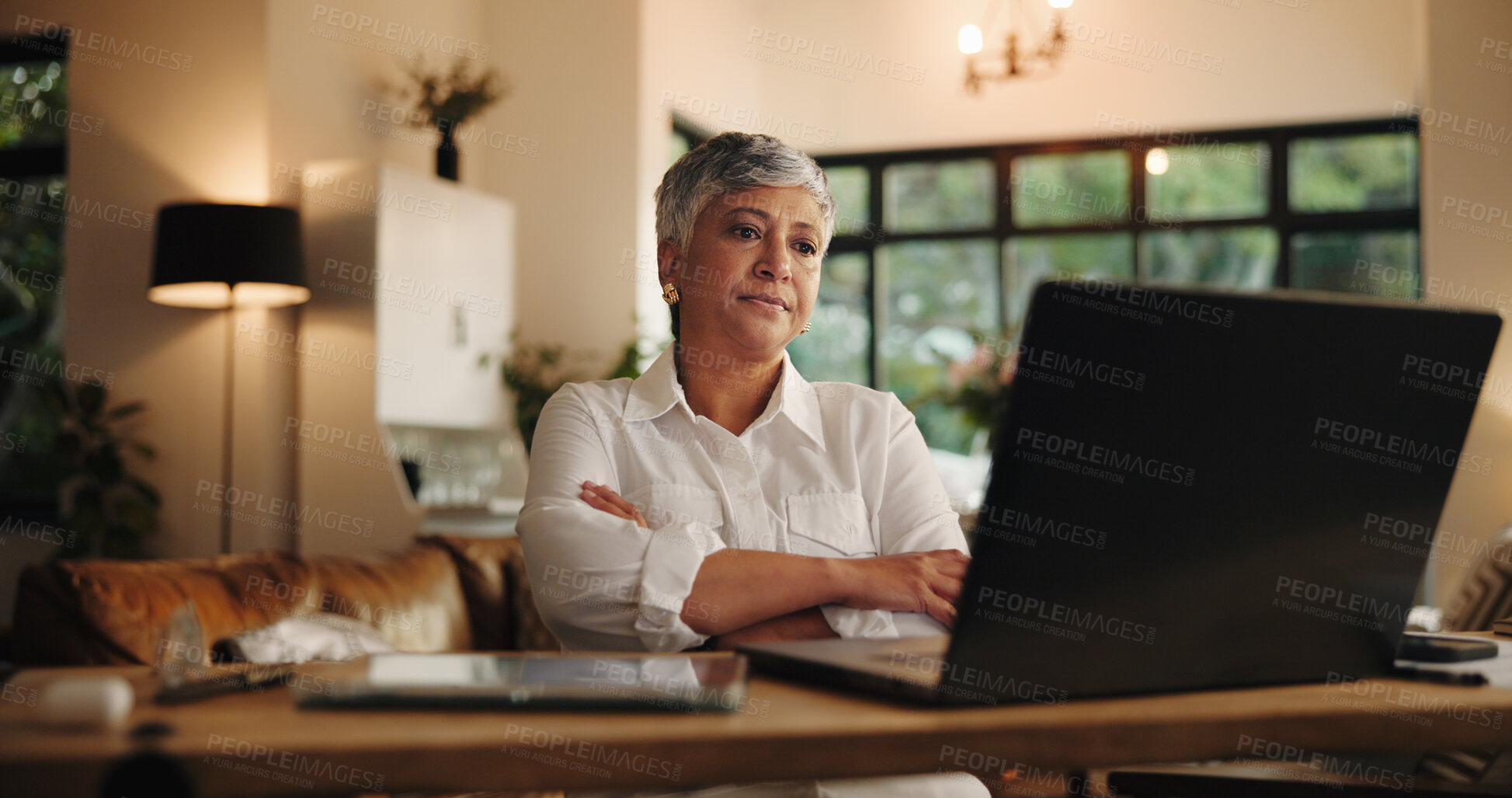 Buy stock photo Senior woman, reading and laptop at house for application, budget and finance report at night. Elderly person, online and feedback for bank loan, retirement funding and deadline for expenses payment