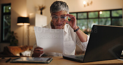 Buy stock photo Home, evening and woman with documents, laptop and proofreading for editing, creative project and glasses. Mature person, employee or journalist with paperwork, pc and late with remote work or smile