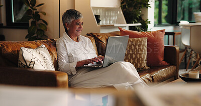 Buy stock photo Mature woman, laptop and typing on sofa with smile for project, ebook and creativity for novel. Person, writer and author with computer on couch, happy and editing process in lounge at apartment