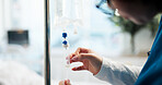 Nurse, hands and iv drip in hospital for medication, illness treatment or patient nutrients. Liquid, woman and monitor intravenous infusion for hydration, anesthesia and prepare prescription medicine