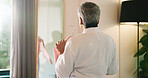 Mature woman, clothes and choice in mirror of bedroom for morning routine, getting ready and style. Back, fashion and person in home with shirt for garment decision, outfit selection and start day
