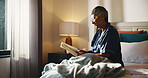 Reading, relax and senior woman with book on bed in home with hobby, literature or knowledge. Smile, fiction and elderly female person in retirement enjoying fantasy story in bedroom of apartment.