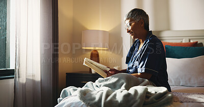 Buy stock photo Reading, relax and senior woman with book on bed in home with hobby, literature or knowledge. Smile, fiction and elderly female person in retirement enjoying fantasy story in bedroom of apartment.