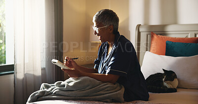 Buy stock photo Home, crossword and senior woman with smile, relax and problem solving with intelligence. Apartment, pensioner and mature person in bedroom, book and games with solution, answer and creative activity