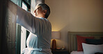Open, window and woman in bedroom, morning or smile for sunrise on weekend, confident and apartment. View, happy and mature person with routine, curtains and wake up in home, fresh air and sunlight