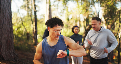 Buy stock photo Marathon, man and check watch in forest for fitness workout, endurance and tracking time. Cardio club, running group and jog together for competition, practice and team exercise for pace training